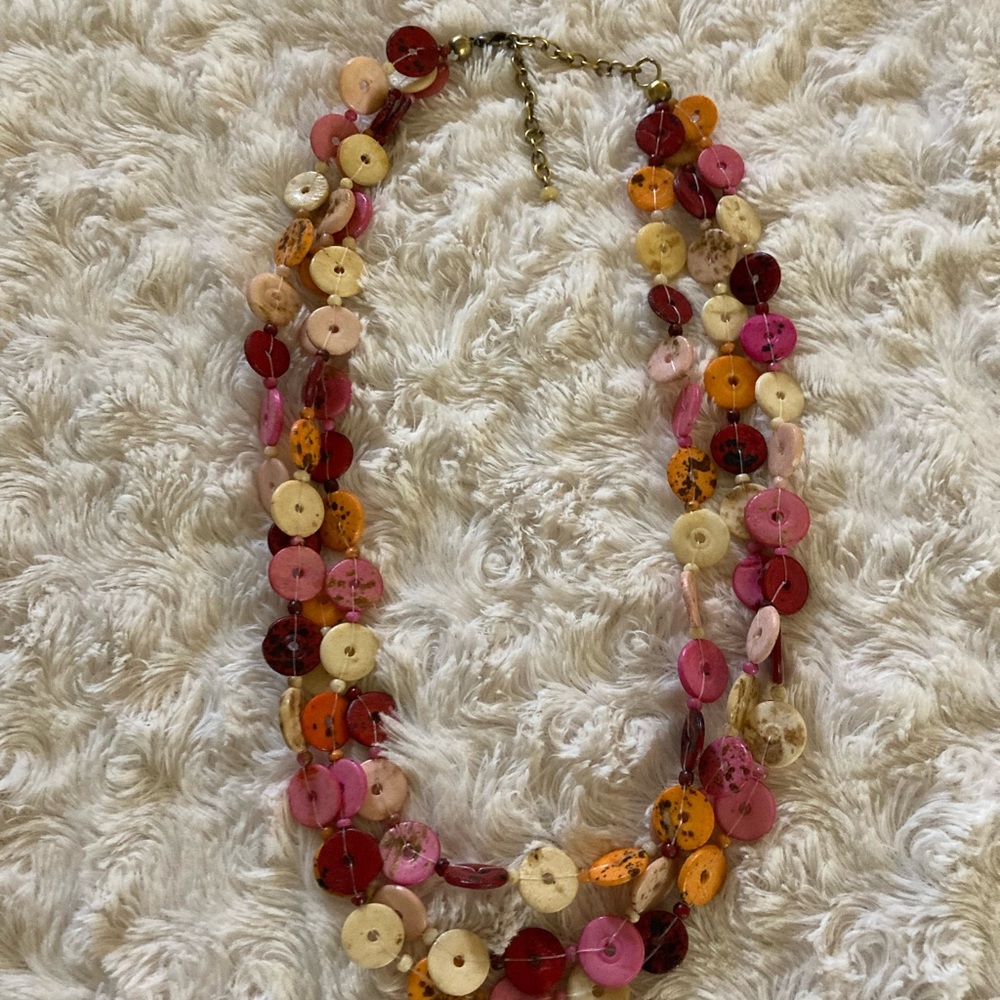 Button necklace-3 strands of varied orange,pink,and red colors
